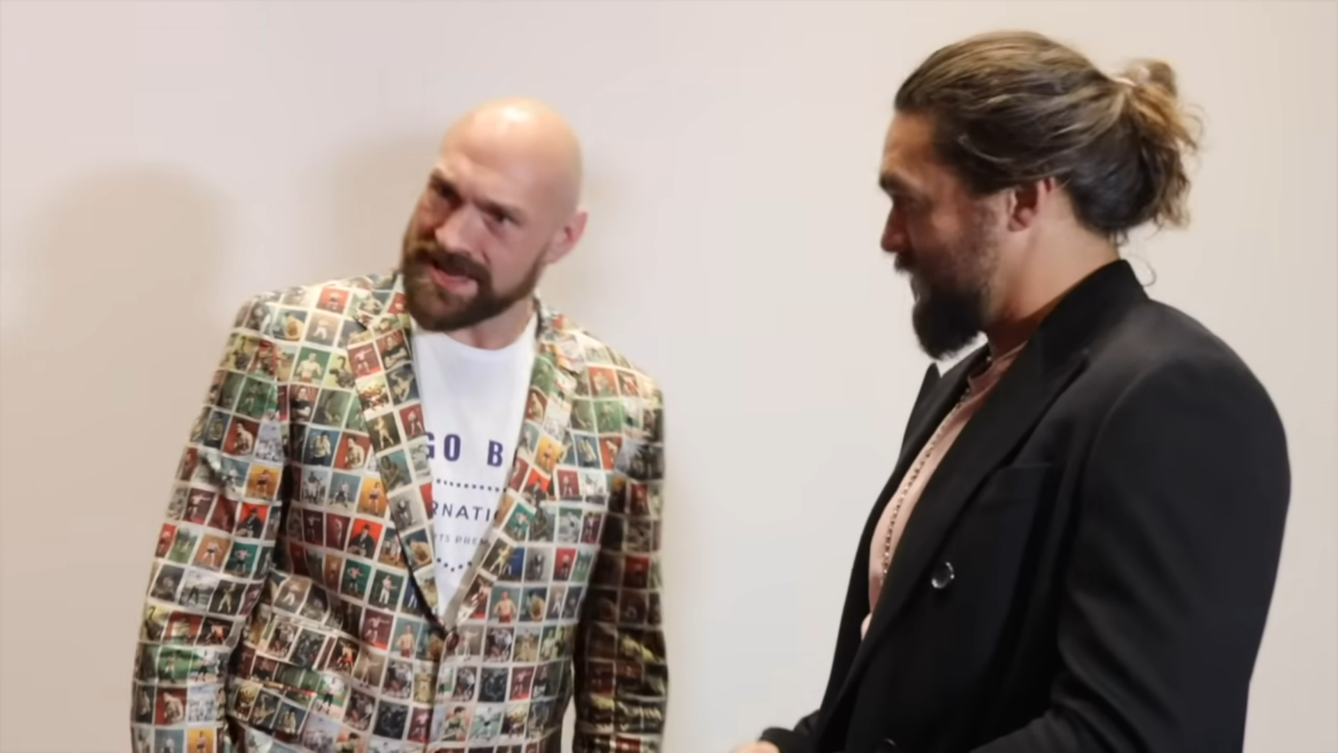 A screenshot from the video where Tyson Fury meets Jason Momoa. The camera perspective makes Fury look smaller. The video paused right after Momoa asked for a photo to which Fury answered with a very sheepish 'yeah' and Fury has an expression that looks straight out of a 'record scratch freeze frame' meme