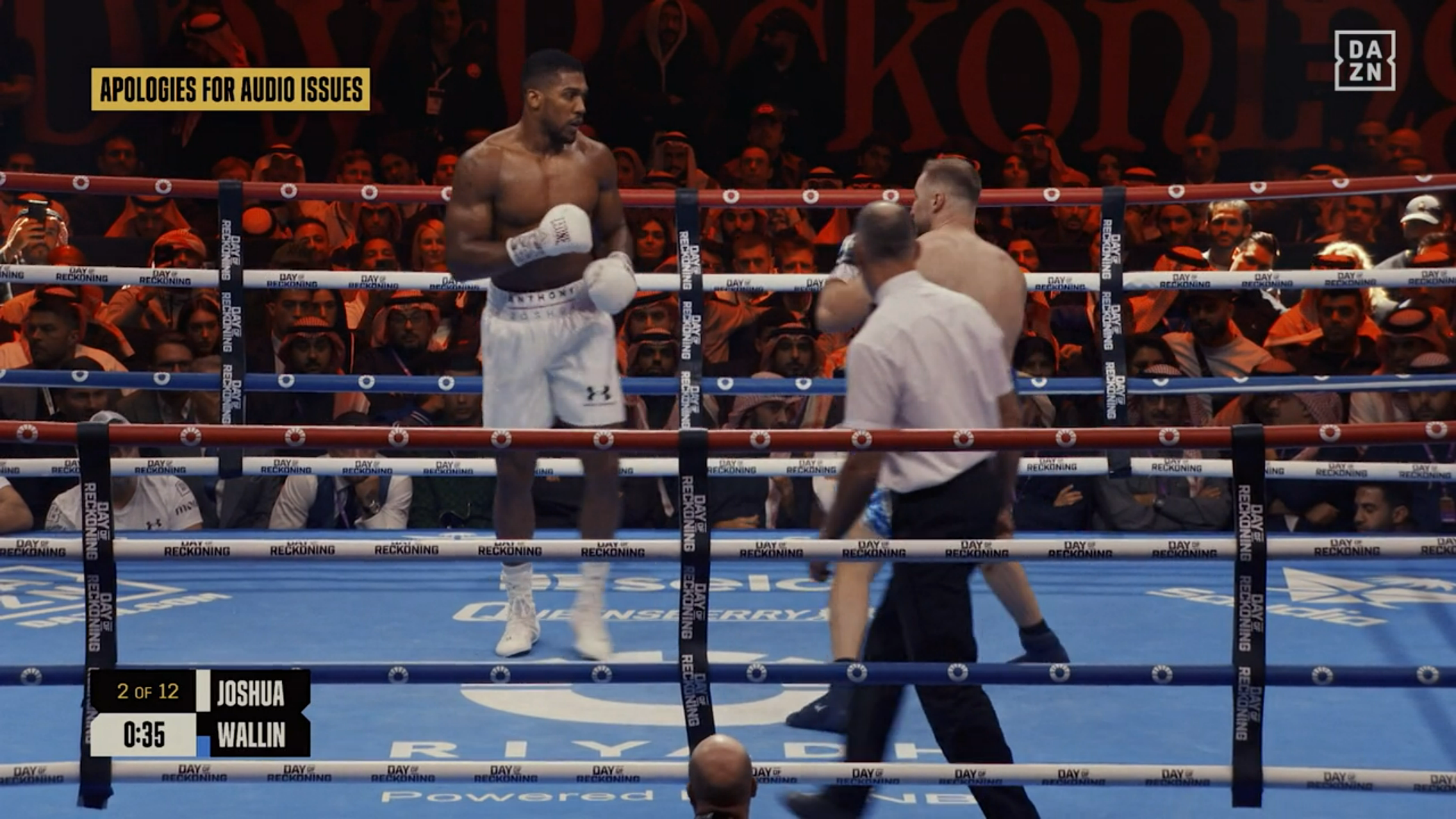 Joshua and Wallin boxing, the on-screen graphics tells us it's 35 seconds into round 2 and at the top left the text says "APOLOGIES FOR THE AUDIO ISSUES"