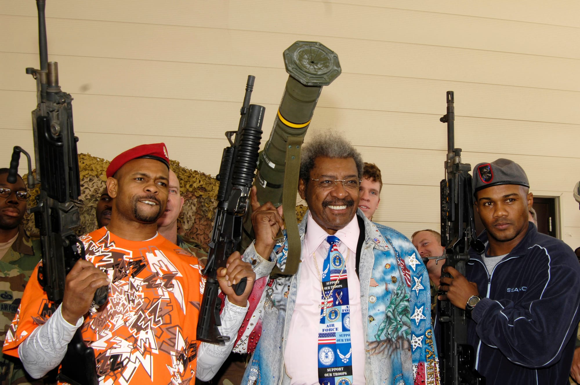 Roy Jones, Don King, and Felix Trinidad holding comically large weapons at a Florida Air Force base in 2007. Jones and Trinidad are wearing military berets. This pic goes hard.