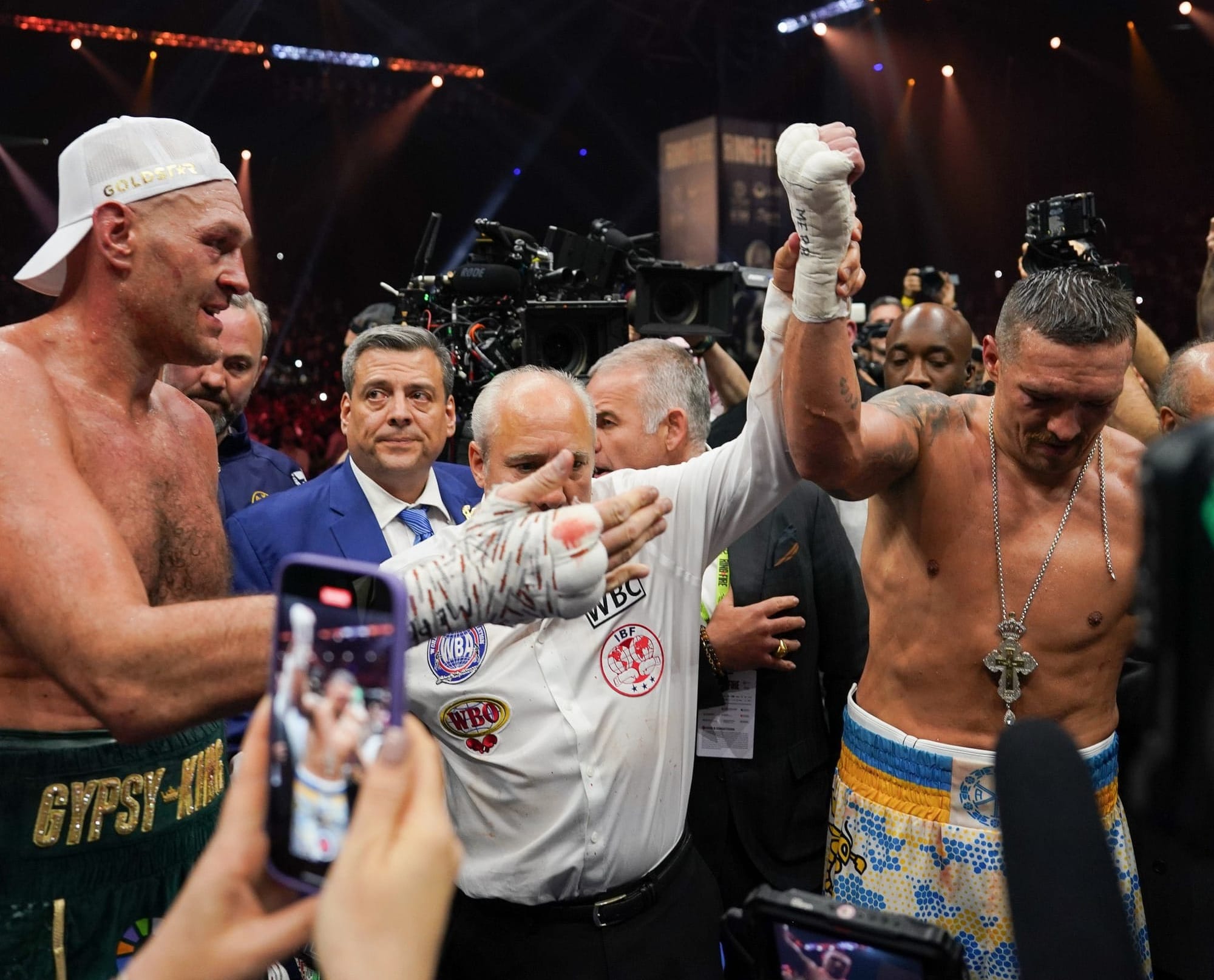 Usyk has his hand raised as the winner by the referee. WBC President Mauricio Sulaiman is absolutely crestfallen and looking at Tyson Fury.