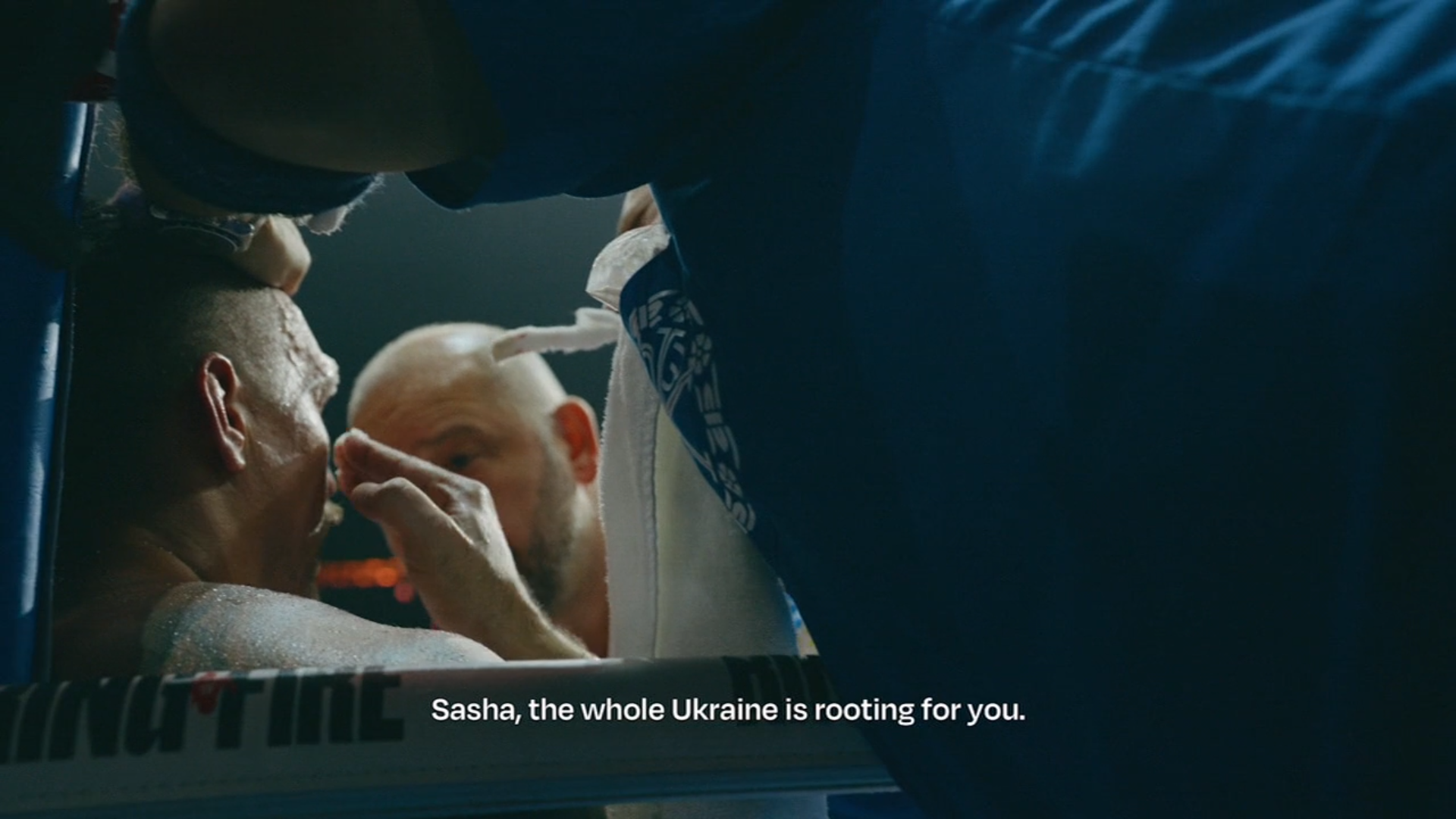 A screenshot from The Fight Life. Usyk getting worked on in his corner, his coach tells him "Sasha, the whole Ukraine is rooting for you."